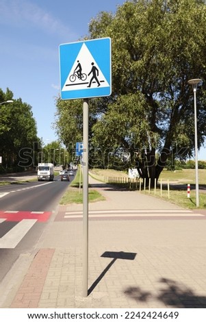 Road sign Pedestrian and Bicycle Crossings outdoors on sunny day