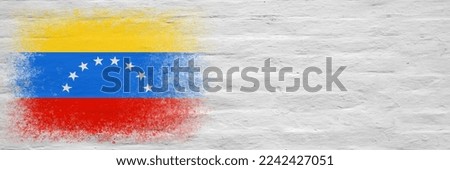 Flag of Venezuela. Flag painted on a white plastered brick wall. Brick background. Copy space. Textured creative background