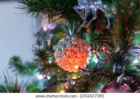 Christmas tree, a detail of the decoration. Christmas balls, lights and colours.