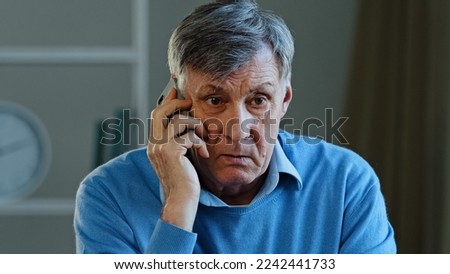 Close-up portrait male sad wrinkled face old caucasian man angry grandpa upset unhappy frustrated senior mature grandpa client talking phone conflict misunderstanding quarrel remote mental problems Royalty-Free Stock Photo #2242441733