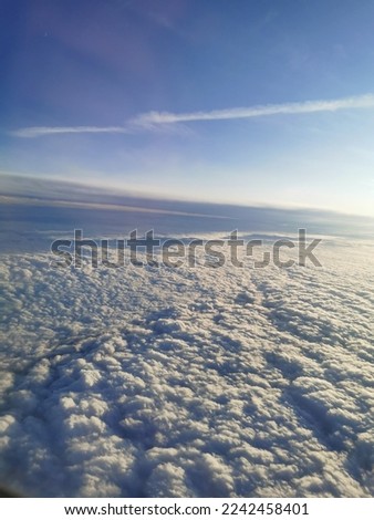 Amazing clouds and the sky as seen through the window of an aircraft