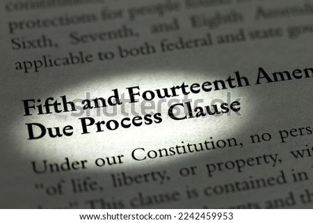 Due process clause to fifth and fourteenth Amendments spotlighted in business ethics textbook on United States law Royalty-Free Stock Photo #2242459953