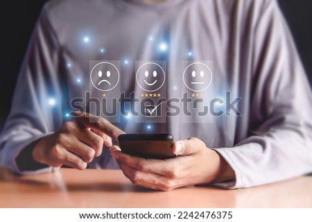 Mobile customers rate service provider satisfaction through an application, service experience in an online application evaluates the quality of service. Royalty-Free Stock Photo #2242476375