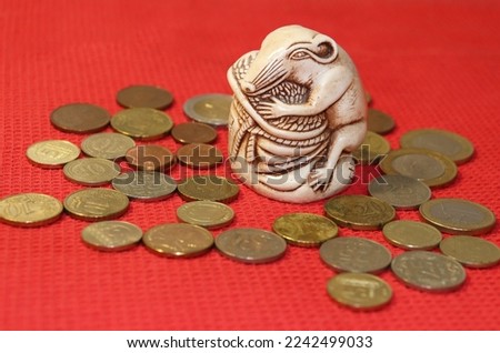 money mouse mascot with grain and coins on a red background