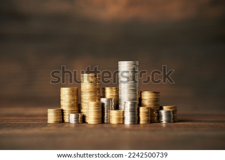 Coins stacks on wooden background. Finance, money, banking and investment concept.