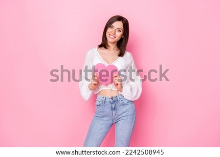 Photo portrait of attractive young girl hold charity cardiology symbol dressed stylish white garment isolated on pink color background