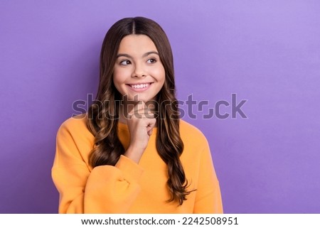 Photo of minded tricky lady trendy winter clothes hand chin look empty space interesting proposition isolated on purple color background