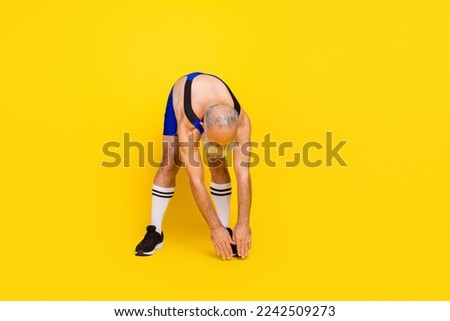 Full length photo of good mood senior guy wear blue overall costume doing inclines empty space isolated yellow color background