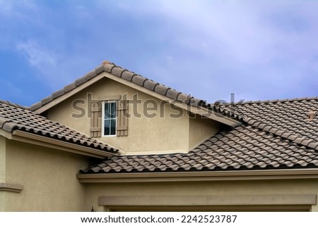 Tiled roof and attic window of a single-family residence, Oasis Community, Menifee, California, USA Royalty-Free Stock Photo #2242523787