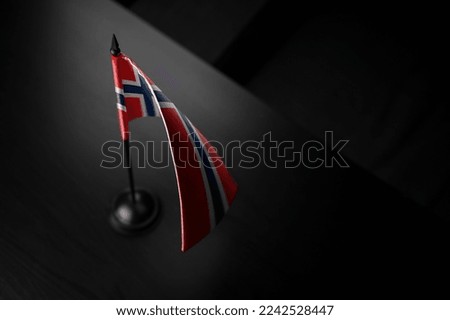 Small national flag of the Norway on a black background.