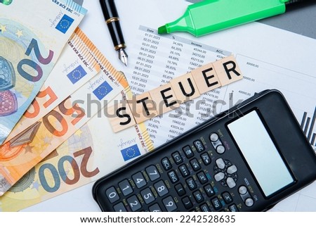 inscription steuer which means Tax in deutsch. Concept showing taxes in Germany Royalty-Free Stock Photo #2242528635
