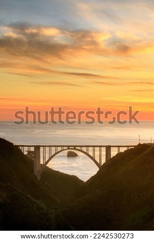 Bixby Creek Bridge with Canyon and Vibrant Sunset. Big Sur, California, USA. Royalty-Free Stock Photo #2242530273