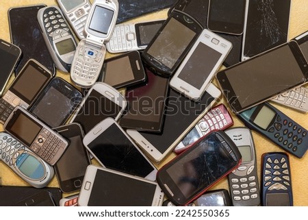 Disused smartphones - recycling of raw materials Cell phone collection campaign Royalty-Free Stock Photo #2242550365