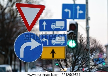 Cars moving on the road in city in winter. View to the traffic with signs, trafficlights and vehicle