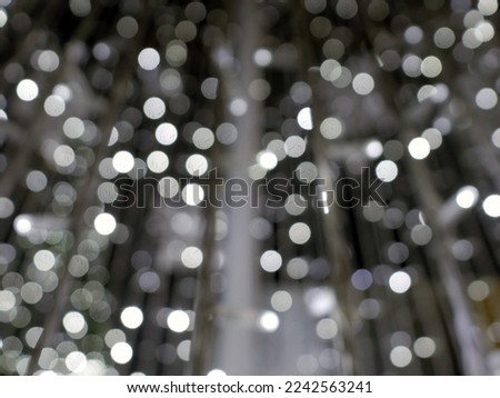 Abstract christmas background in bokeh. Yellow lights of blinking garland in blur. Unsharp bulbs of Christmas decorations. Festive mood. Background for text or pictures. New Year holiday