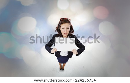 Top view of excited businesswoman holding white blank banner. Place for text
