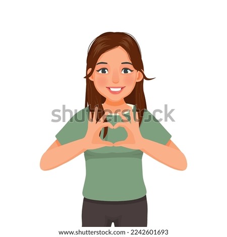 happy young woman showing heart shape sign with hands gesture 