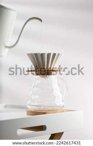 Clean the filter paper before drip coffee Royalty-Free Stock Photo #2242617431