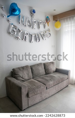 Aluminum foil balloons for Birthday party banner hanging on the wall, happy birthday balloon in family room, interior