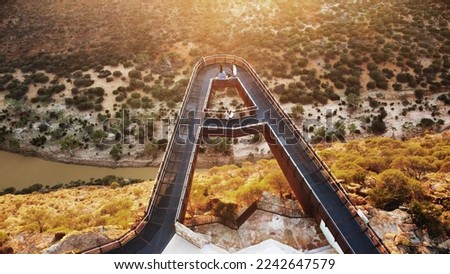 Breathtaking twin skywalks in Kalbarri National Park boast stunning vistas of the Murchison River Gorge's rust-red cliffs, flowing water and bushland Royalty-Free Stock Photo #2242647579