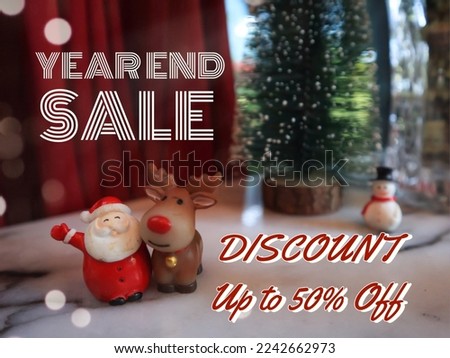 Poster of Year end sale discount up to 50% off that is decorated by Christmas dolls concept such as Santa Claus and Reindeer toys.