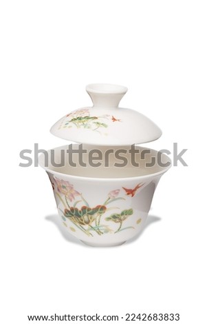 Detailed shot of a white original porcelain color printed gaiwan  in chinese style. The designer bowl with a raised lid is isolated on the white background.