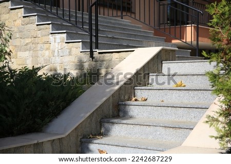 View of beautiful grey concrete stairs near plants outdoors