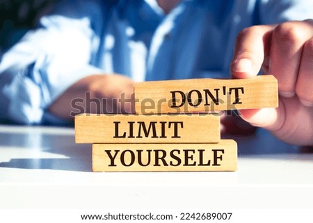 Wooden blocks with words 'Don't Limit Yourself'.