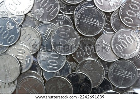 Many shiny Indonesian coins as background, top view