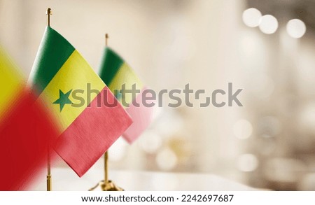 Small flags of the Senegal on an abstract blurry background. Royalty-Free Stock Photo #2242697687