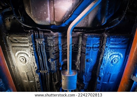 Vehicle underbody exhaust pipe, catalyst, resonator, exhaust system. Car service and maintenance. Standards and technical condition. anti-corrosion coating of the bottom of the car Royalty-Free Stock Photo #2242702813