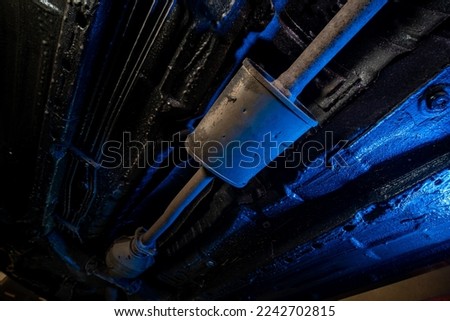 Vehicle underbody exhaust pipe, catalyst, resonator, exhaust system. Car service and maintenance. Standards and technical condition. anti-corrosion coating of the bottom of the car Royalty-Free Stock Photo #2242702815