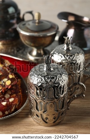 Tea and Turkish delight served in vintage tea set on wooden table, closeup
