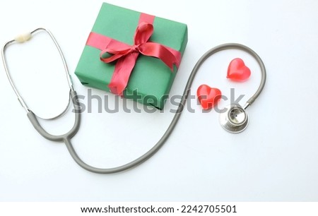 Heart icon and medical stethoscope, gift box on white background. Health care,christmas and new year,valentine's day concept