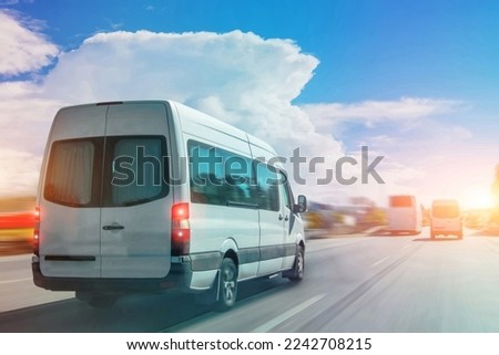 Passenger white bus van accelerating ride motion blur effect Royalty-Free Stock Photo #2242708215