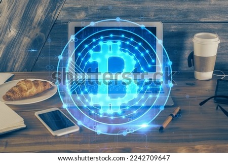Double exposure of blockchain theme hologram and table with computer background. Concept of bitcoin crypto currency.