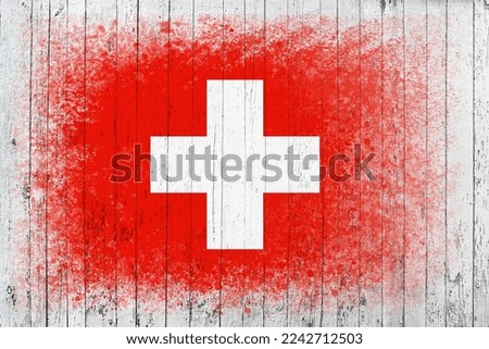 Flag of Switzerland. Flag is painted on a white wooden surface. Wooden background. Plywood surface. Copy space. Textured creative background