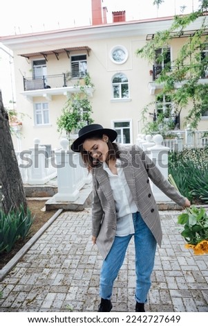 woman with sunflower flowers on the street