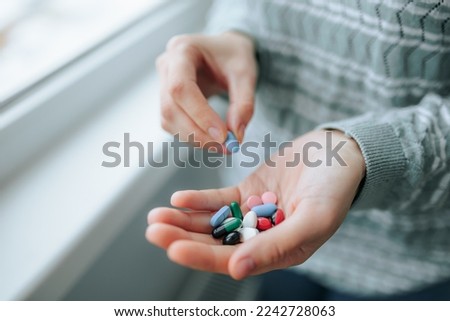 Full palm of vitamins and minerals to drink. Health concept. Top view, close up. At home. Close up full palm tablets of different shapes, different sizes, enzymes, analgesics, painkillers,  Royalty-Free Stock Photo #2242728063