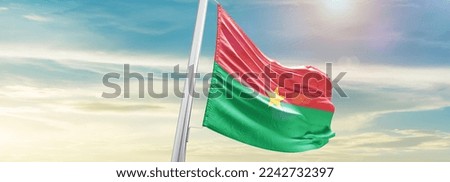 Burkina Faso Flag on pole for Independence day. The symbol of the state on wavy cotton fabric.