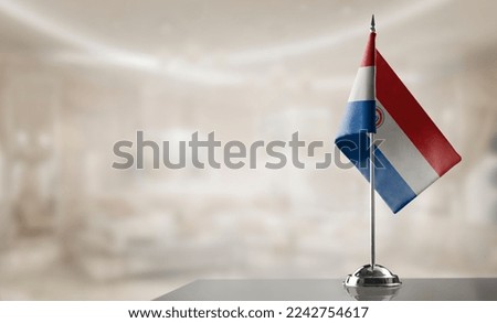 A small Paraguay flag on an abstract blurry background. Royalty-Free Stock Photo #2242754617