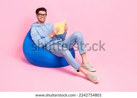 Photo of smart clever guy sitting home relax rest comfort bag like read fiction genre empty space isolated on pink color background
