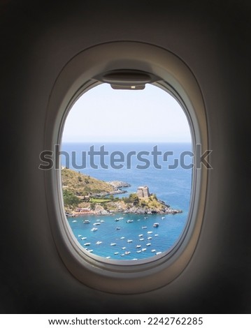 Airplane window with beautiful sky. Airplane window. View of the sea, mountains and clouds. Travel and tourism concept. New scenic spots.