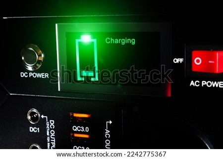 Discharged or low battery level.
Control panel display of lithium Portable Power Station. Charging laptop smartphones, power banks and other gadgets. Modern, information technology.
