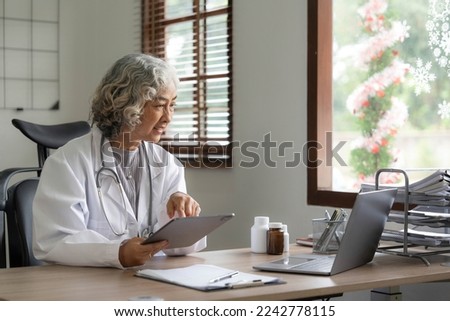 Asian senior doctor hospital medical medicine health care clinic office. using laptop computer.

