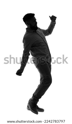Silhouette of young man dancing on white background