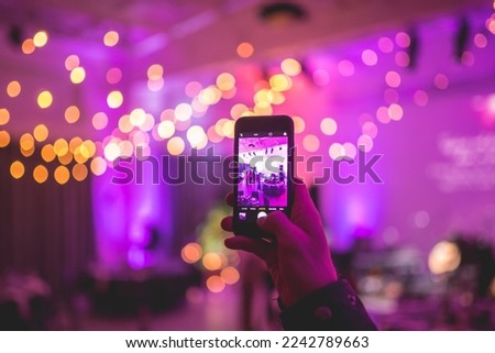 Taking photos of decorations with a smart phone in an event