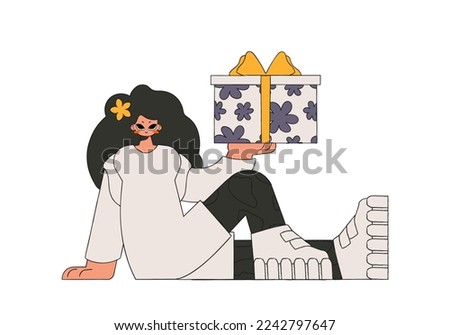 The girl is holding a gift box in her hands. Holiday gift theme.