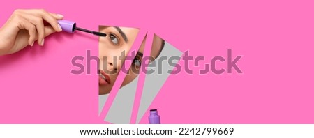 Beautiful young woman with mascara visible through cut pink paper. Banner for design