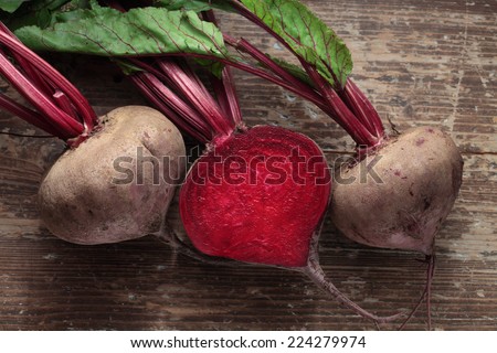 Beetroot with herbage on wooden background Royalty-Free Stock Photo #224279974